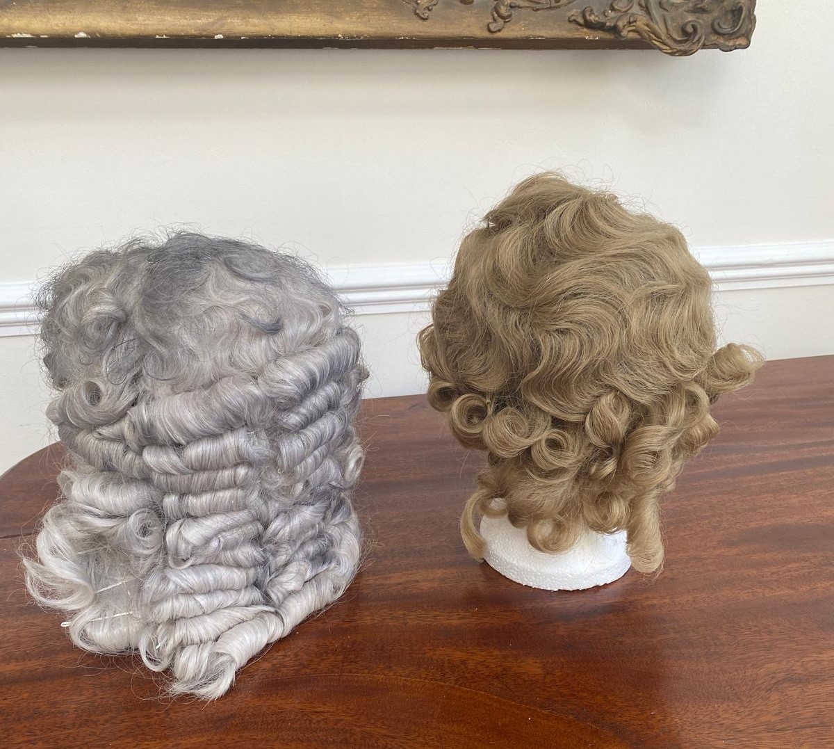 A lady’s 1930’s real hair wig with lacing and a men’s 18th century style acrylic wig